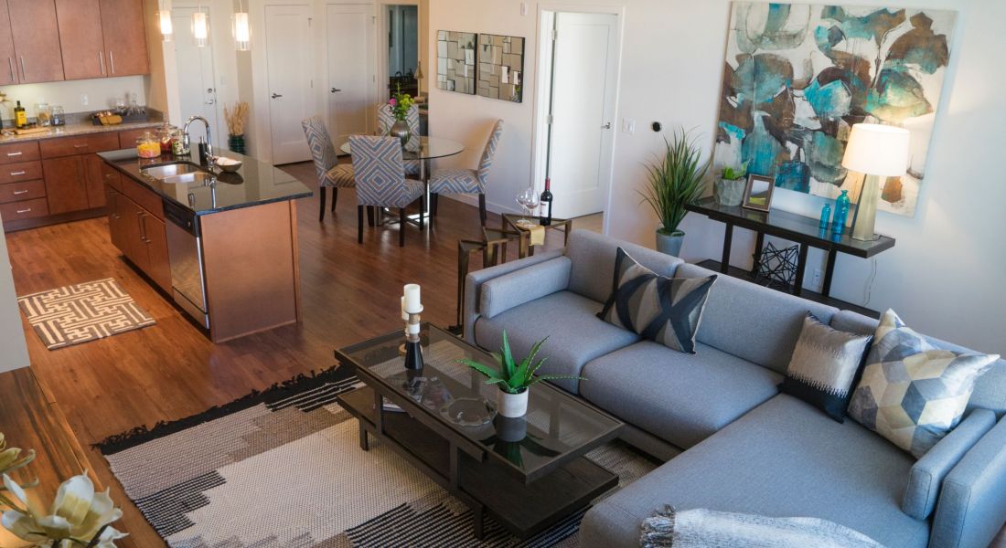 Domain City Center Contemporary open-plan living room and kitchen in a stylish apartment setting.