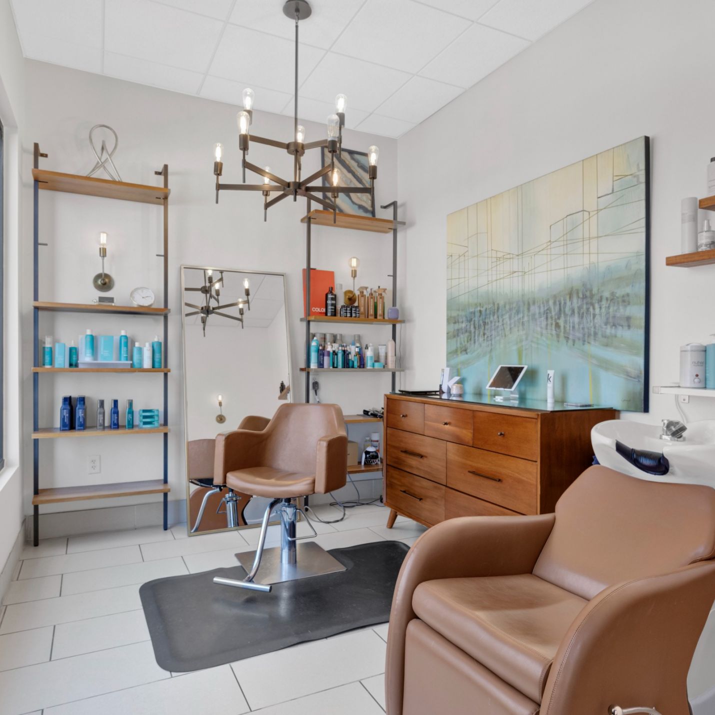 Domain City Center Interior view of a salon with stylish chairs and a prominent large painting enhancing the ambiance.