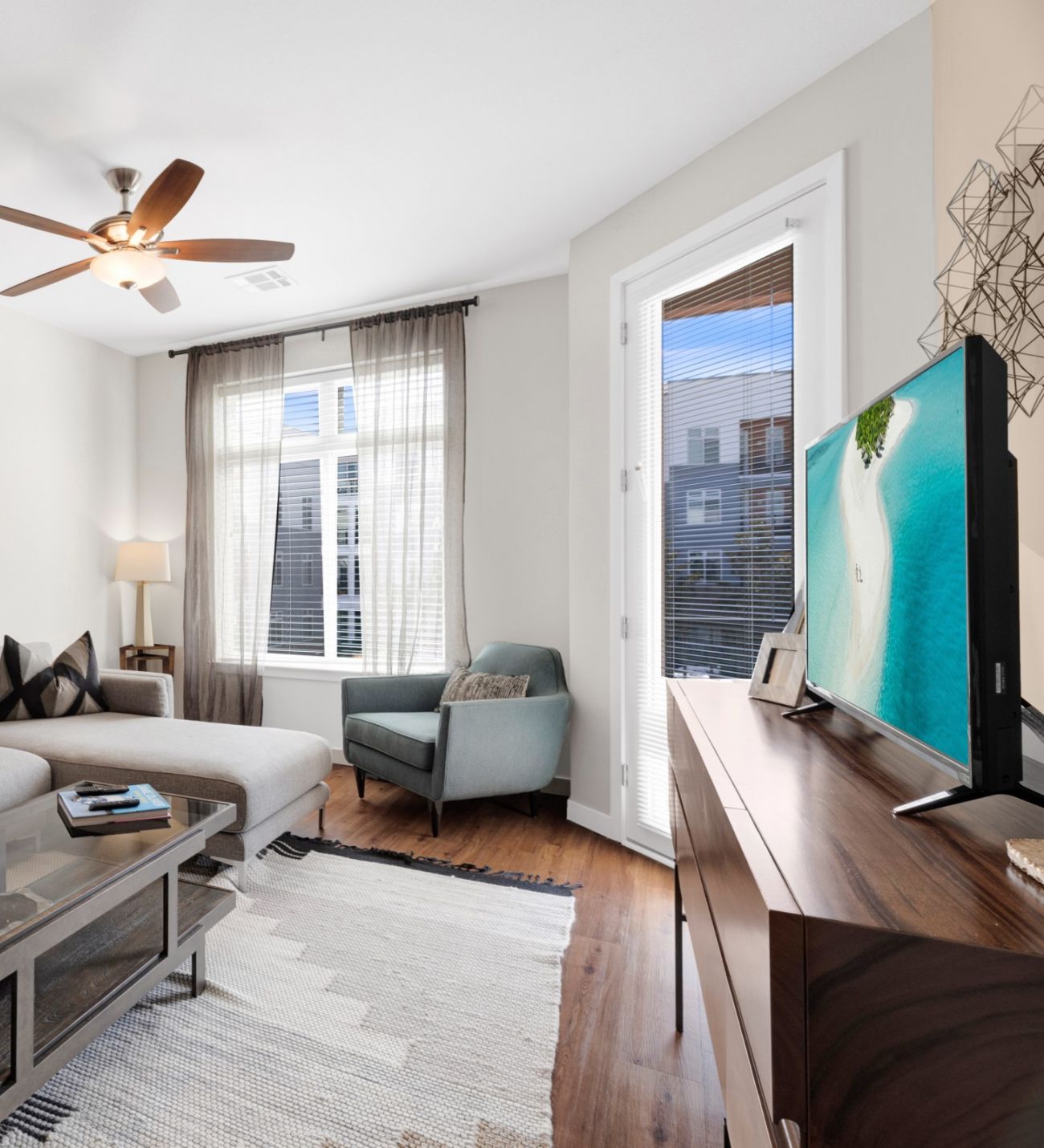 Domain City Center A cozy living room featuring a couch, coffee table, and a television set against a neutral wall.